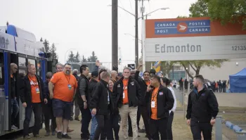 Bus full of ATU members unload bus at the Edmonton Postal Station to support and walk the line with striking CUPW postal workers.
